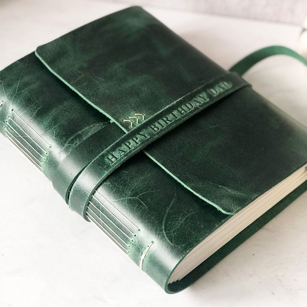 Green leather-bound book with custom embossed HAPPY BIRTHDAY DAD  on the strap