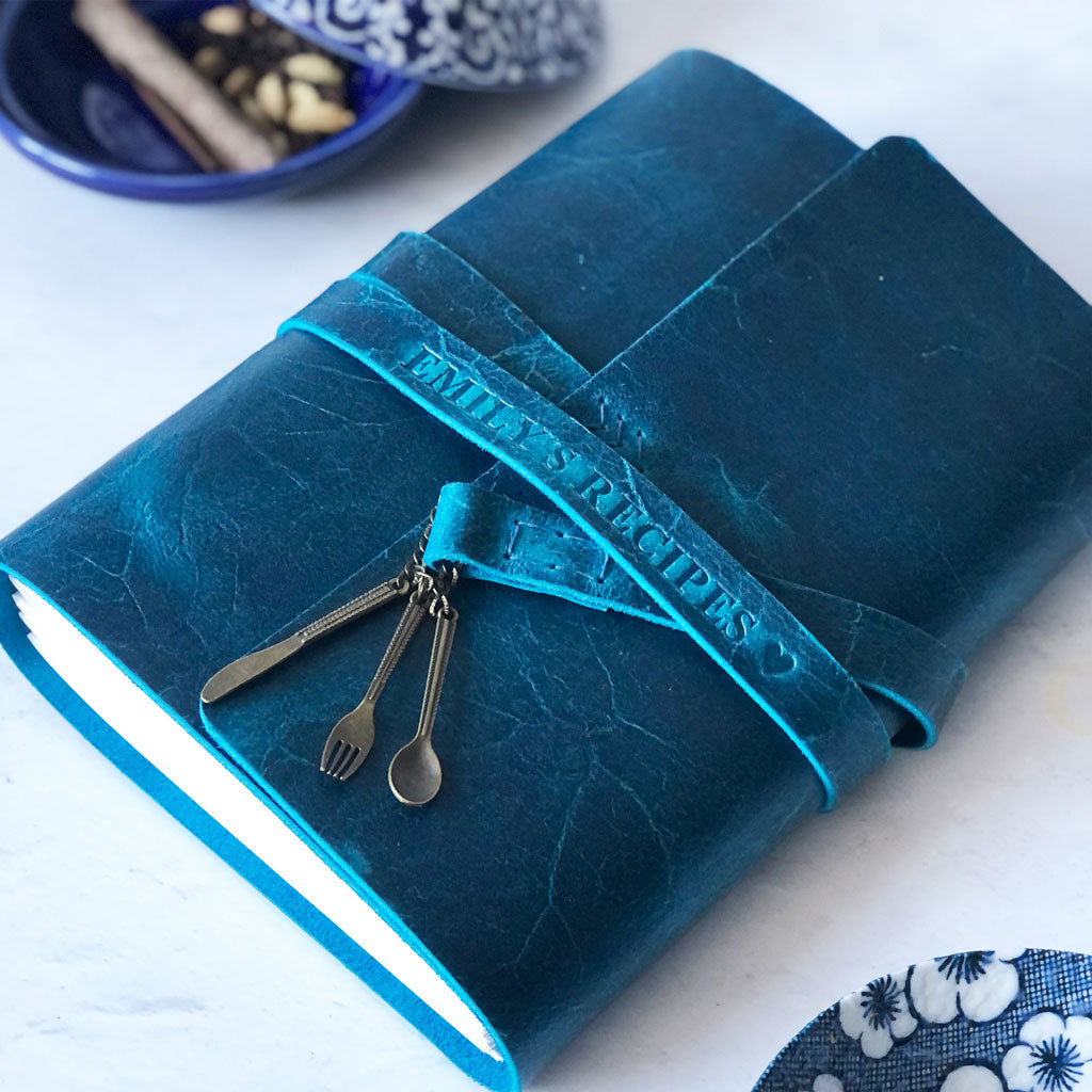 Blue leather-bound recipe book with utensil charms custom embossed name