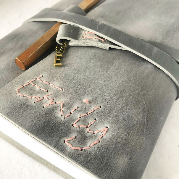 Hand stitched name on leather, detail