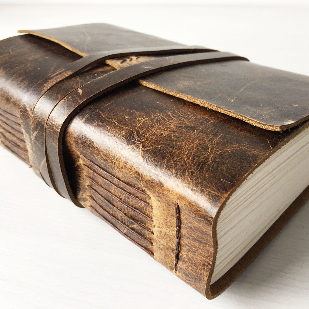 Large rustic brown leather sketchbook side view