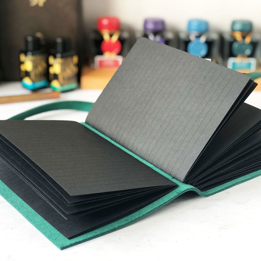 Leather notebook with black lined paper