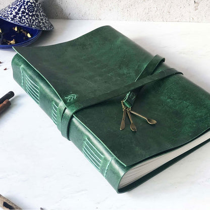 A4-sized recipe book with a green leather cover and a cutlery charm detail