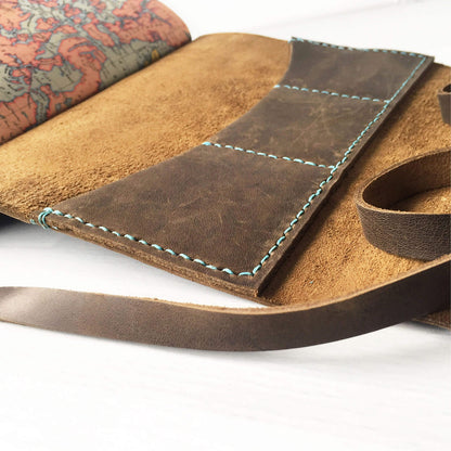 Open book view of  saddle stitched travelers notebook with card slots