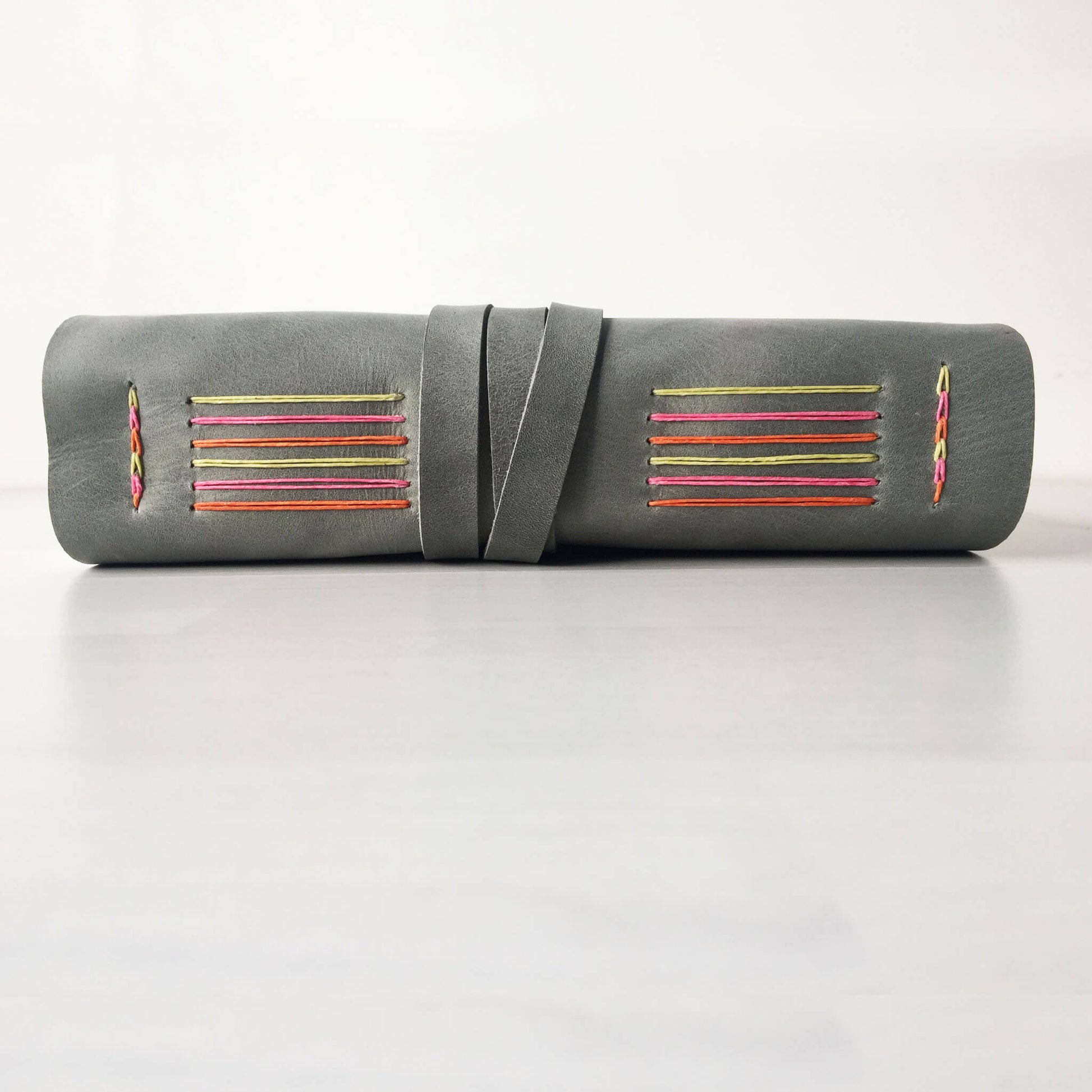 Custom sketchbook grey leather with rainbow stitching side view