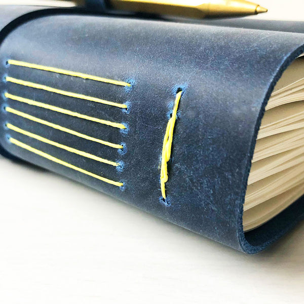 Indigo leather, lemon yellow binding, side view