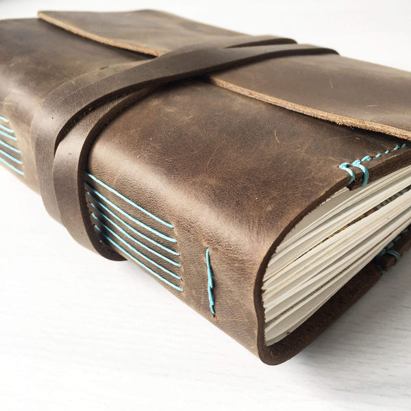 A5 brown leather with turquoise stitching side longstitch binding view