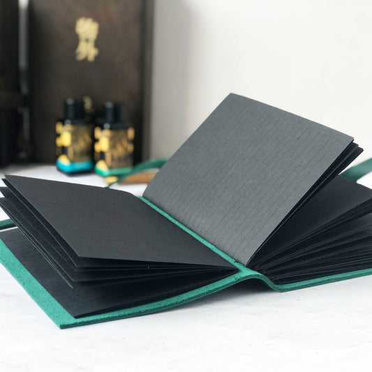 Leather journal with lined black pages