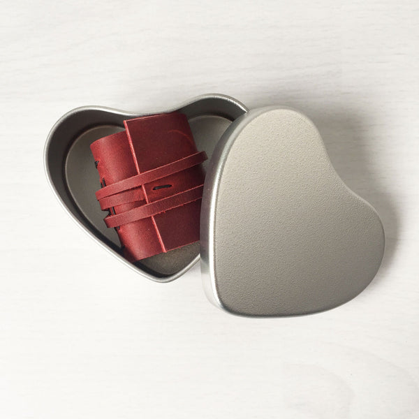 miniature leather book in a heart tin