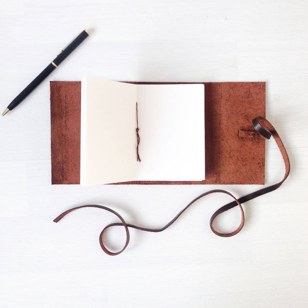 Open pages of brown leather mini sketchbook
