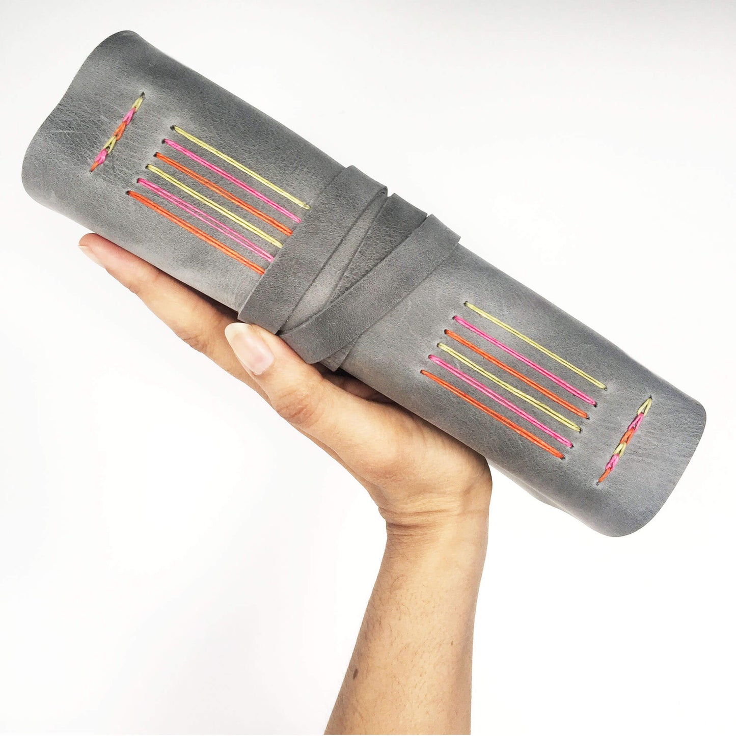 Grey travel diary with rainbow stitching, side view