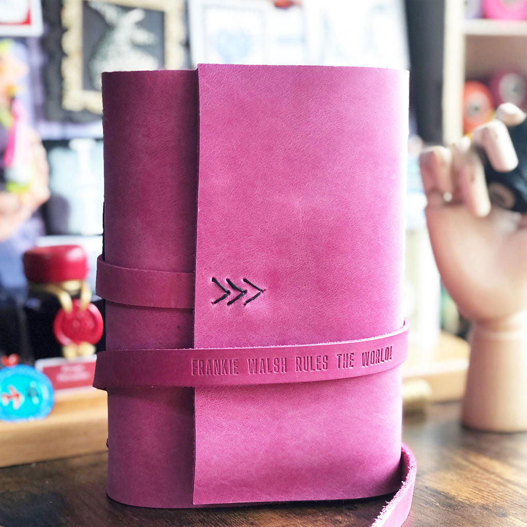 Pink leather wrap journal with custom embossed quote on strap